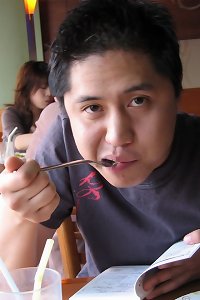 a asian man and a woman in black lingerie play with the naked cock of another dude
